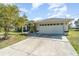 A well-maintained home with a large garage, screened entry, and landscaped front yard at 4010 Yucatan Cir, Port Charlotte, FL 33948