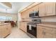 Well-equipped kitchen featuring wooden cabinets, stainless steel appliances, and ample counter space at 4010 Yucatan Cir, Port Charlotte, FL 33948