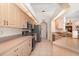 Spacious kitchen with stainless steel appliances, light wood cabinets, and tiled flooring at 4010 Yucatan Cir, Port Charlotte, FL 33948
