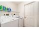 Laundry room features a washer, a dryer and wire shelving above appliances at 4010 Yucatan Cir, Port Charlotte, FL 33948