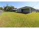 The large backyard features a covered patio and plenty of room for outdoor activities at 4071 Conestoga St, Port Charlotte, FL 33948