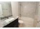 Clean bathroom features a shower-tub, dark vanity, and granite countertops at 4071 Conestoga St, Port Charlotte, FL 33948