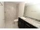 Modern bathroom features granite countertops, a dark vanity, and a walk-in shower with stylish tile at 4071 Conestoga St, Port Charlotte, FL 33948