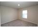 Bright bedroom featuring neutral tones, carpet flooring, and a bright window for natural light at 4071 Conestoga St, Port Charlotte, FL 33948