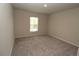 Cozy bedroom featuring neutral tones, carpet flooring, and a bright window for natural light at 4071 Conestoga St, Port Charlotte, FL 33948