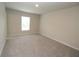 Bright bedroom featuring neutral walls, carpet flooring, and a window offering natural light at 4071 Conestoga St, Port Charlotte, FL 33948