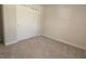 Neutral bedroom featuring a closet with sliding doors, neutral carpet and natural lighting at 4071 Conestoga St, Port Charlotte, FL 33948