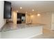 Spacious kitchen with a granite countertop island, stainless steel appliances, and ample cabinet space at 4071 Conestoga St, Port Charlotte, FL 33948