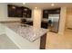 Stylish kitchen with granite counters, stainless appliances, and dark cabinets, perfect for any home chef at 4071 Conestoga St, Port Charlotte, FL 33948