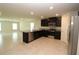 Modern kitchen featuring dark cabinetry, granite counters, and stainless steel appliances at 4071 Conestoga St, Port Charlotte, FL 33948