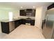 Modern kitchen featuring stainless steel appliances, dark cabinetry, and granite countertops, perfect for culinary enthusiasts at 4071 Conestoga St, Port Charlotte, FL 33948