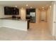 Well-equipped kitchen with granite countertops, stainless steel appliances, and dark cabinets, ideal for cooking at 4071 Conestoga St, Port Charlotte, FL 33948