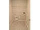 A basic laundry room provides essential hookups and a wire shelf for storage and supplies at 4071 Conestoga St, Port Charlotte, FL 33948