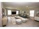 Bright living room featuring tile floors, area rug, comfortable seating, and plenty of natural light at 4071 Conestoga St, Port Charlotte, FL 33948