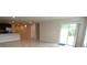 Open-concept living area showcasing tile flooring and sliding glass doors leading to the outdoor space at 4071 Conestoga St, Port Charlotte, FL 33948