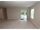 Open-concept living area with tile floors, sliding glass door, and windows for natural light at 4071 Conestoga St, Port Charlotte, FL 33948