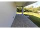 An inviting covered patio featuring stylish pavers and views of the lush backyard, perfect for relaxing or entertaining at 4071 Conestoga St, Port Charlotte, FL 33948