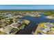 Scenic aerial shot of waterfront homes, lush landscaping, and access to expansive waterways and canal at 4174 Perch Cir, Port Charlotte, FL 33948