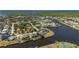 Wide aerial shot displaying waterfront homes, canal access, landscaping, and overall community layout at 4174 Perch Cir, Port Charlotte, FL 33948