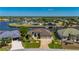 Stunning waterfront property showcasing lush greenery, a boat dock, and a beautiful neighborhood setting at 4174 Perch Cir, Port Charlotte, FL 33948