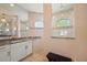 Bright bathroom featuring white cabinetry, granite counters, and a tiled walk-in shower with natural light at 4174 Perch Cir, Port Charlotte, FL 33948