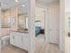 Bright bathroom featuring white cabinetry, granite counters, tiled flooring, and a walk-in shower at 4174 Perch Cir, Port Charlotte, FL 33948
