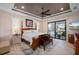 Primary bedroom with a four-poster bed, neutral colors, and a sliding glass door to the outdoor area at 4174 Perch Cir, Port Charlotte, FL 33948