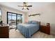 Bedroom featuring tiled floors, a ceiling fan, and sliding doors to the backyard at 4174 Perch Cir, Port Charlotte, FL 33948