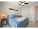 Cozy bedroom features a ceiling fan, a shelf, and a comfortable bed with a wood headboard at 4174 Perch Cir, Port Charlotte, FL 33948