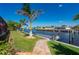 This lush backyard features a well-maintained lawn, waterfront access, and private dock at 4174 Perch Cir, Port Charlotte, FL 33948
