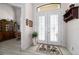 Inviting foyer with double doors, tile flooring, and a view into the living area at 4174 Perch Cir, Port Charlotte, FL 33948