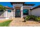 Charming home with a tile walkway leading to a grand arched entry and double doors at 4174 Perch Cir, Port Charlotte, FL 33948