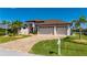 Beautiful home with a three-car garage, manicured lawn, and a curved driveway, displaying curb appeal at 4174 Perch Cir, Port Charlotte, FL 33948
