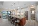 Bright kitchen boasts stainless steel appliances, a large island with seating, and modern white cabinetry at 4174 Perch Cir, Port Charlotte, FL 33948