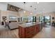 Open concept kitchen with island and seating flowing into a living room with fireplace and pool view at 4174 Perch Cir, Port Charlotte, FL 33948