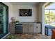 Outdoor kitchen has a modern mini-refrigerator and sink with stylish granite countertops at 4174 Perch Cir, Port Charlotte, FL 33948