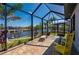Inviting lanai has waterfront views and comfortable seating at 4174 Perch Cir, Port Charlotte, FL 33948