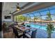 Inviting lanai featuring a dining area with a view of the pool and waterfront at 4174 Perch Cir, Port Charlotte, FL 33948