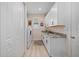 Well-lit laundry room with modern washer and dryer, abundant storage, and a countertop with granite at 4174 Perch Cir, Port Charlotte, FL 33948