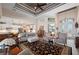 Bright living room with ceiling fan, lots of light and open access to kitchen with modern white cabinets at 4174 Perch Cir, Port Charlotte, FL 33948