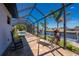 Enjoy relaxing on this screened in patio with canal views from lounge chairs or rocking chairs at 4174 Perch Cir, Port Charlotte, FL 33948