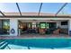 Inviting backyard patio with seating areas that is accessible directly from the refreshing screened-in pool at 4174 Perch Cir, Port Charlotte, FL 33948