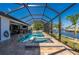 Beautiful screened-in pool and hot tub with pavers and ample space for entertaining near the canal at 4174 Perch Cir, Port Charlotte, FL 33948