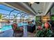 Stunning pool area features a spa, outdoor seating, and beautiful waterfront views at 4174 Perch Cir, Port Charlotte, FL 33948