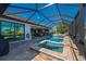 Stunning screened-in pool and hot tub with direct access to the home's interior through sliding glass doors at 4174 Perch Cir, Port Charlotte, FL 33948