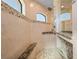 Walk-in shower featuring natural stone accents, a built-in bench, and a shower head at 4174 Perch Cir, Port Charlotte, FL 33948