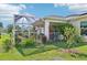 The backyard features a screened lanai, garden, and beautifully maintained lawn at 4463 Cromey Rd, North Port, FL 34288