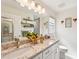 Bathroom with granite countertops, dual sinks, and framed mirrors at 4463 Cromey Rd, North Port, FL 34288
