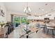 Bright dining area with tile flooring, modern lighting, and a seamless transition to the outdoor living space at 4463 Cromey Rd, North Port, FL 34288