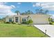 Charming single-story home features a well-manicured lawn, inviting front porch, and a convenient two-car garage at 4463 Cromey Rd, North Port, FL 34288